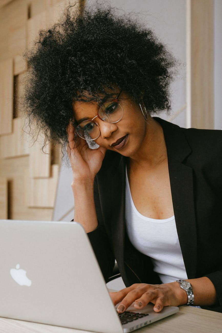 woman in black blazer wearing eyeglasses